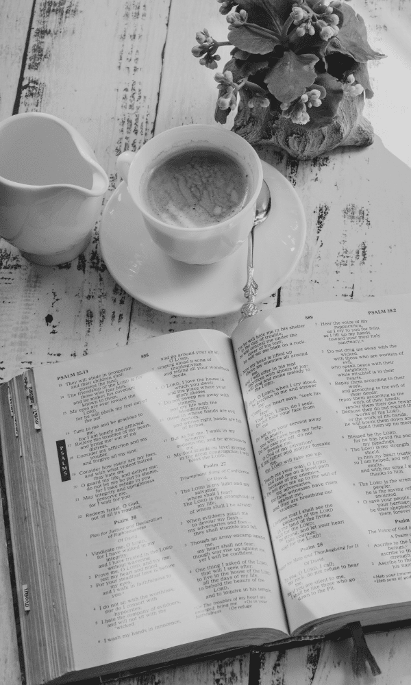 Open Bible with cup of coffee on table