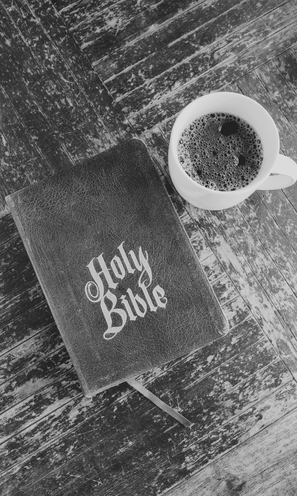 Picture of bible and cup of coffee on wooden table